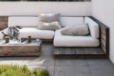 08 a weathered corner wood seating with white cushions and pillows