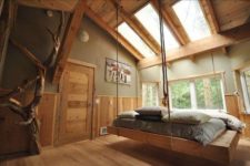 08 modern wooden hanging bed in a natural bedroom with skylights