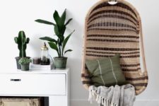 08 striped wicker chair suspendedin a living room makes the ambience relaxing