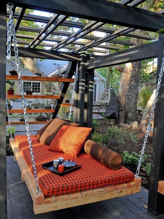 a cozy pallet hanging bed attached to its own stable base