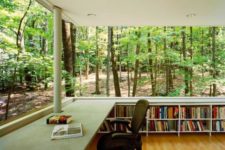 12 a fully glazed home library and office creates an effect of sitting in the forest