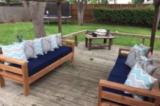 19 stained wood sofas with navy cushions and patterned pillows