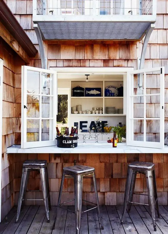 a simple window and an outdoor windowsill to use it as an outdoor bar or breakfast space
