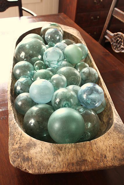 fishing floats in a wooden dough bowl is a creative beach inspired display