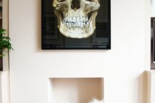 03 a black and gold skull wall art will make a glam space more dramatic
