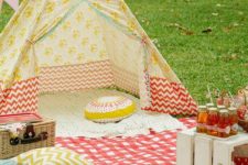 03 a bold printed teepee with colorful blankets and pillows, ideal for kids’ games
