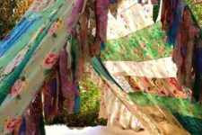 04 colorful patchwork boho tent with a faux fur blanket and fringe, a couple of pillows
