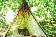 06 a boho teepe with herbs and flowers, colorful pillows and blankets