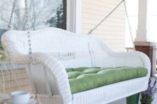 06 a white wicker swing is a traditional piece for a porch, and it makes it welcoming and peaceful, and your rest joyful
