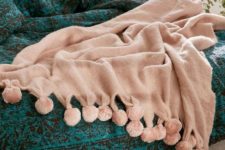 08 a blush blanket with pompoms is a cozy and cute idea for summer