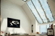 08 an industrial bedroom with large windows coming into skylights and then a glazed ceiling to flood the space with light