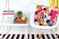 09 a colorful pompom throw pillow will spruce up your space for summer and make it bolder