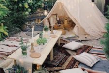 10 a neutral teepee in the backyard, with a small wood coffee table, and a picnic setting