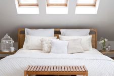 10 a small attic space with three skylights instead of a headboard is a nice idea to get natural light