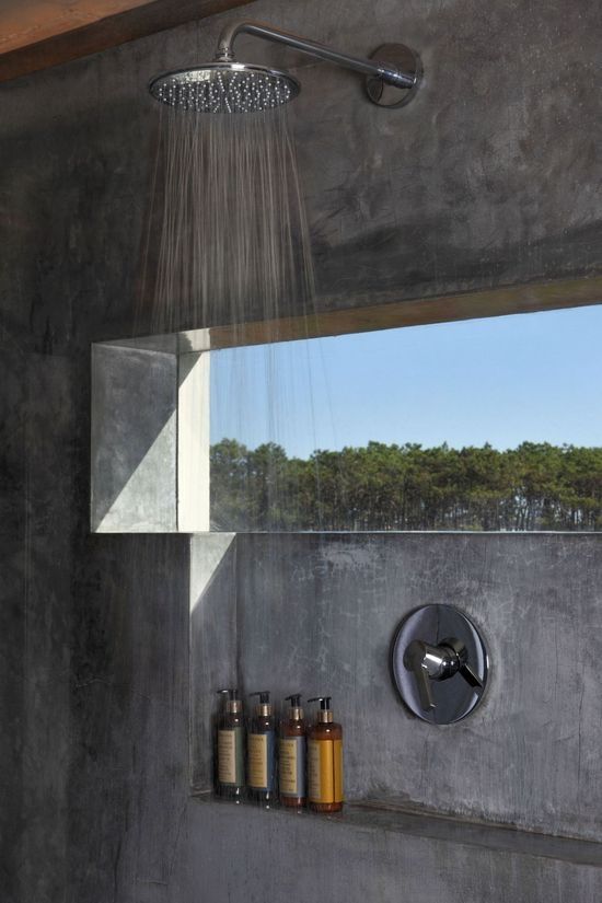 a concrete shower with a small window allows keeping maximal privacy while enjoying the views