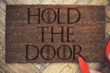 11 a door mat with famous ‘Hold the door’ print