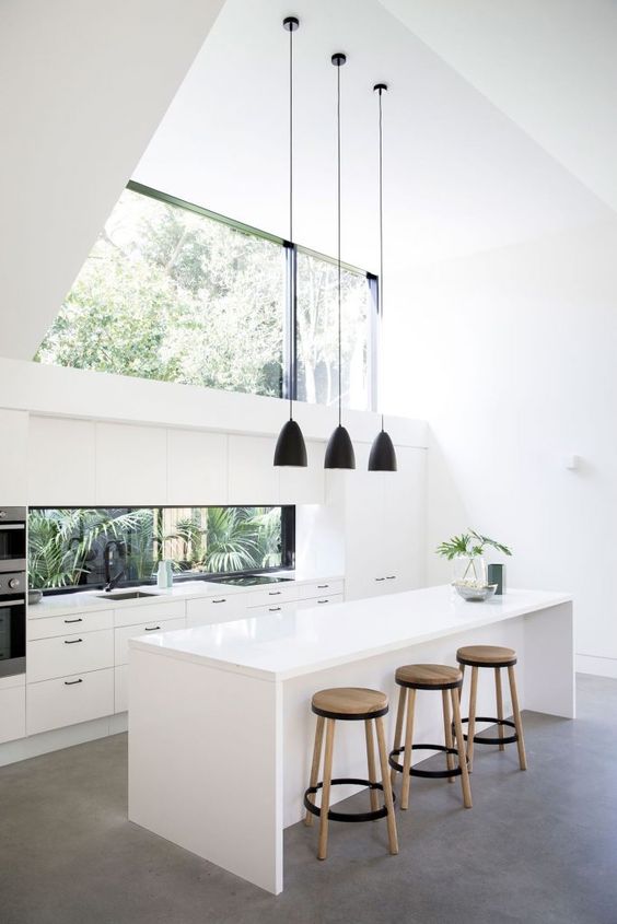 a double height ceiling is taken advantage with the help of a large window-like skylight