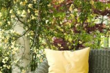 13 a rattan swing of a dark shade will stand out in the backdrop of gorgeous summer blooms