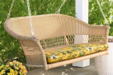 14 a resin wicker loveseat swing with a bold tropical print cushion to embrace the season