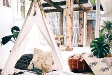 14 a small kids teepee with a dreamcatcher, covered with white and with cute pillows