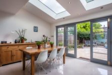 15 a modern dining space with a skylight and additional lights around it