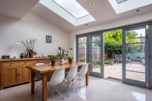 a modern dining space with a skylight and additional lights around it