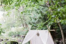 16 a small teepee with white lace fabric, a candle lantern and crate coffee table