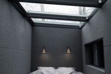 16 an ultra-minimalist masculine bedroom with a glazed ceiling as a focal point of the space