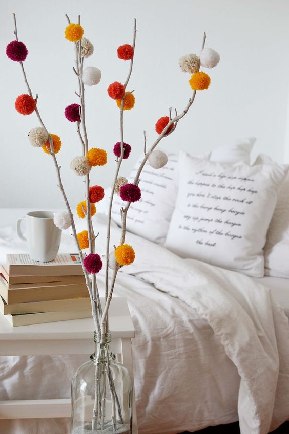 make an arrangement using branches and colorful pompoms for a long-lasting look