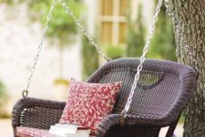16 traditional brown wicker swing with a cushion is a great relaxing piece for any outdoor space