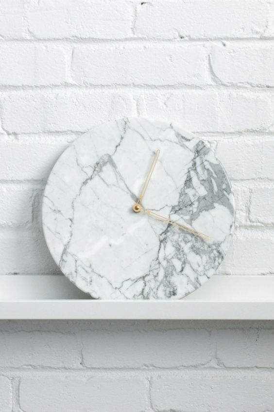 take a usual clock, cover it with marble wallpaper and change detailing for metallic
