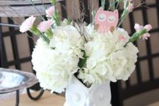 02 a centerpiece of a white owl vase, white and pink blooms and a pink cardboard owl