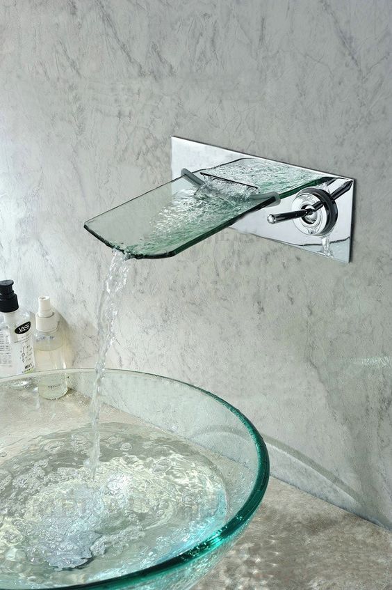 a sheer round glass sink and a glass faucet is ideal for a modern bathroom