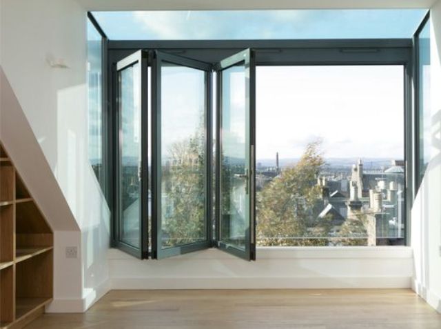 a folding glass window is an entrance to the balcony