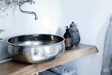 04 a gorgeous textural metal bowl sink contrasts a rough wood vanity and creates a bold look