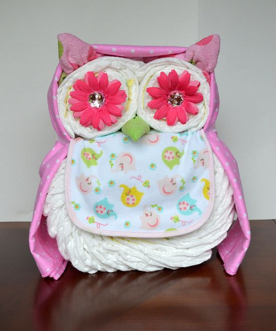 an owl diaper cake in pink for a girl's baby shower