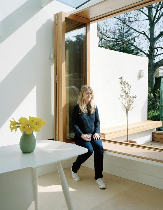 a low window sill in the dining space and a foldable window to enjoy the views and fresh air