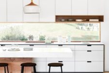07 a modern white kitchen with metal stools and reclaimed wood is enlivened with a window backsplash