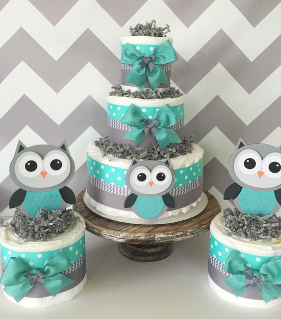 a trio of diaper cakes in grey and turquoise for a boy's baby shower
