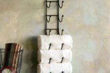 08 a forged shelving unit with towels is a comfy piece to use and space-saving