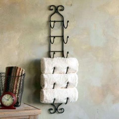 a forged shelving unit with towels is a comfy piece to use and space saving
