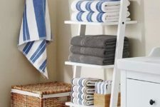 09 a ladder used for towel and bathroom accessories storage is a space-savvy idea