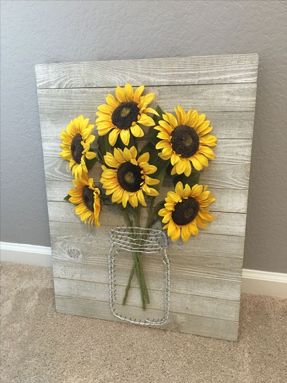 a rustic pallet sign with wire and faux sunflowers is ideal for wall decor