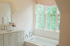 10 peaceful girlish bathroom with a small crystal chandelier and a blush curtain