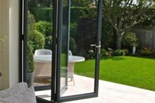 11 a black framed folding door helps to open the space to the backyard