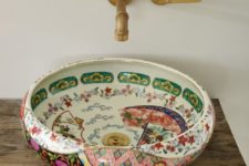 11 a bold painted porcelain bowl sink contrasts a rough wood stand