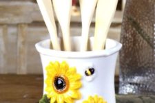 11 a utensil holder of porcelain with sunflowers is ideal for kitchens