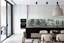 11 matte white cabinets and a black kitchen island with a narrow kitchen backsplash