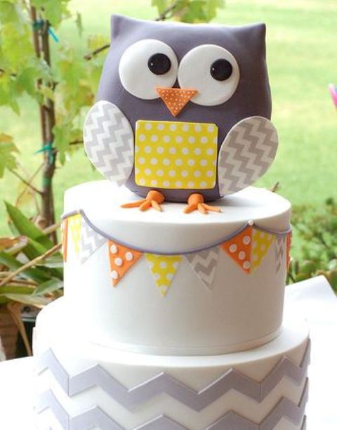 a grey and yellow large owl baby shower cake with a banner