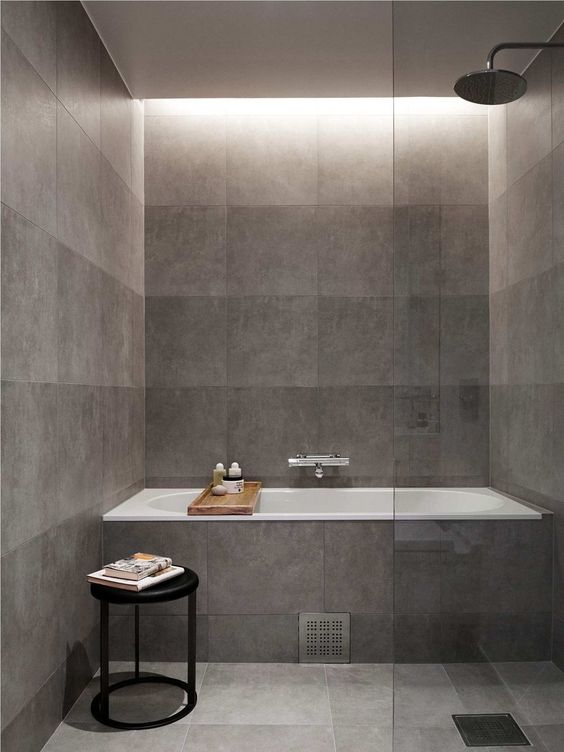 grey tile bathroom is made lighter with natural light coming from above